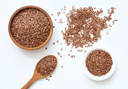 flat lay top view flaxseed or linseed in spoon and bowl isolated on white background. flat lay top view flaxseed or linseed in spoon and bowl isolated on white food background. flaxseed or linseed