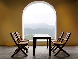 Wooden table set up view arch window view of mountain
