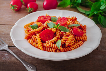 Fusilli pasta with tomato sauce and basil