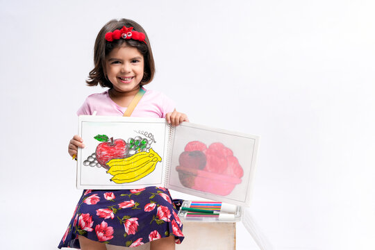 indian little girl showing drawing on white background
