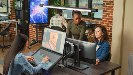 Employees doing it work to develop new interface in agency studio, content creators analyzing...
