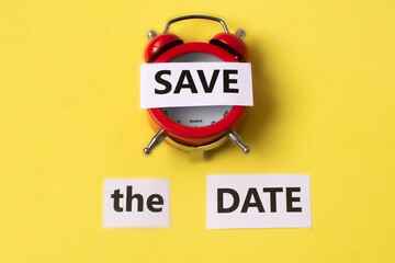 Save the date on a red wake on a yellow background. Date, save, greeting.