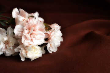 A bouquet of carnations lies on the table