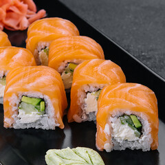 Delicious philadelphia sushi on black stone plate