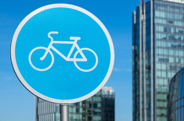 Bicycle sign in the city on the background of buildings