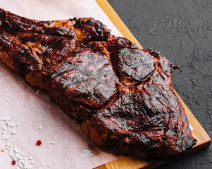 Freshly grilled Tomahawk steak on wooden cutting board