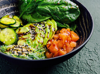 poke bowl with salmon, avocado and cucumber