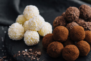three types of chocolate balls on stone board