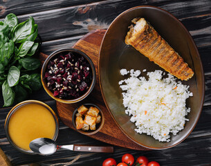 Roast fish with white rice on a cutting board