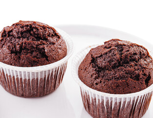Chocolate cupcakes on a plate isolated on white