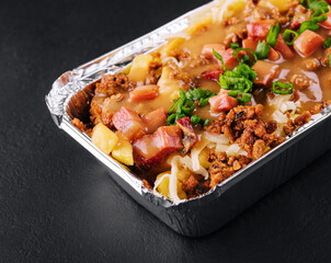 Lasagna with meat on black background