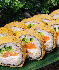 Sushi rolls tempura with salmon on plate. Japanese food style.