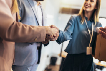 Young woman having first working day getting acquainted with colleagues