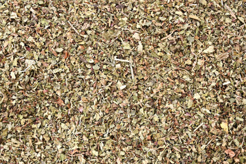 Dried lemon balm (Melissa officinalis) pile background. Lemon balm spice. Bio organic lemon balm tea. Lemon balm tea Herbs dry leaf.