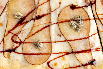 Closeup on gourmet pizza with pear and gorgonzola cheese