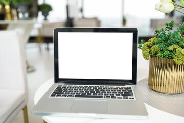 Laptop with Mock up blank screen on table in front of cafe space for text. product display computer laptop montage- technology concept