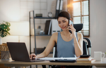 Asian young woman working online at home.