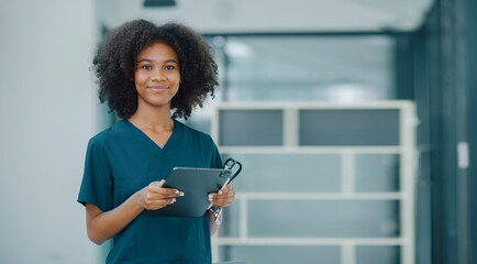 African American female doctor using digital tablet at hospital, Healthcare professional and medical concepts.