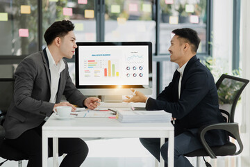 Technology and financial advisory services concert. Business teamwork and working on digital laptop computer with advisor showing plan of investment to clients at table office. Digital marketing.