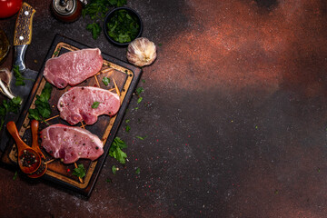Raw pork meat steaks cooking background