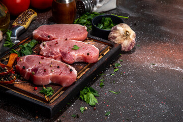 Raw pork meat steaks cooking background