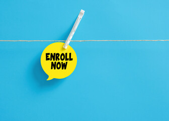 Enroll now message on a speech bubble hanging on clothesline with a clothespin.