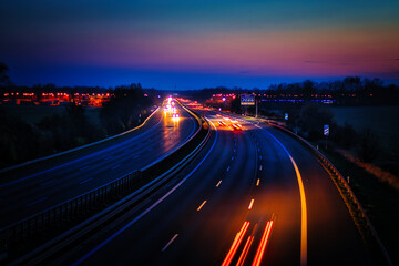 Fototapeta na wymiar Langzeitbelichtung - Autobahn - Strasse - Traffic - Travel - Sunrise - Line - Ecology - Highway - Night Traffic - Long Exposure - Cars Speeding - Lights - Sunset - Light Trails - High quality photo