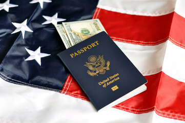US citizen's passport with embedded US dollar banknotes on the US flag. Identity document. Selective focus
