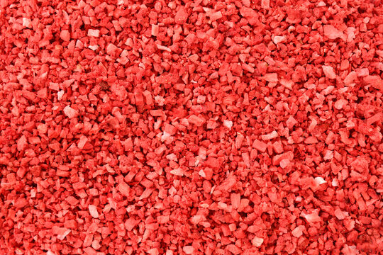 Strawberry food background. Strawberries texture. dehydrated, dried Strawberry pieces, coarse cuts, chips. Heap of freeze dried strawberries. sweet fruit background. Red background stock image.