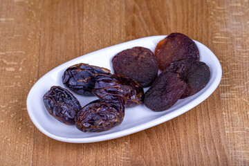 Dried apricots and date furit. Naturally Dried apricots and dates in a ceramic bowl