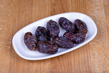 Date fruit. Naturally date palm fruit in a ceramic bowl. Ramadan food