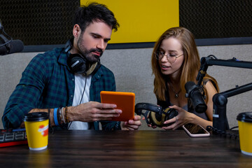 Young man and woman looking involved while searching something online