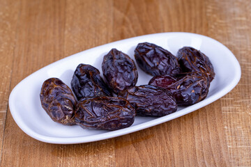Date fruit. Naturally date palm fruit in a ceramic bowl. Ramadan food. Close up