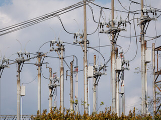 Electricity distribution station. Lots of wires, poles and shields. Spring, on the background of...