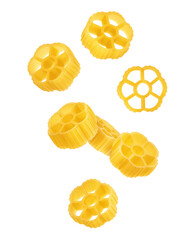 Falling raw Rotelle, uncooked Italian Pasta, isolated on white background, full depth of field