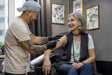 Tattoo master preparing client for a tattoo session