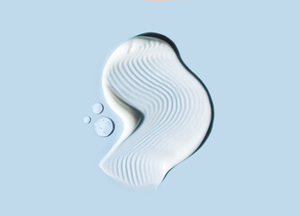 cosmetic smears cream texture on blue background