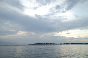 Obraz premium Lombok and Gili Air islands, overcast, cloudy day, sky and sea. Sunset, sand beach.