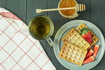 Fresh Belgian waffles with fruits, top view. Tasty breakfast