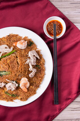 wok fried fu Zhou braised ee fu noodle bee hoon longevity noodle mee with seafood mushroom prawn egg meat and vegetables on wood table asian chinese halal food menu for restaurant