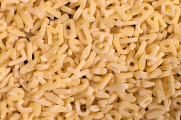 Macaroni shaped letters, alphabet pasta background, texture