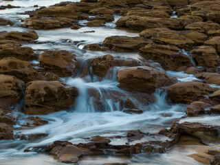 Sunrise and cascades over the rock platform