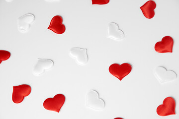 Fototapeta na wymiar Red and white silk hearts isolated on white background. Valentine's day or Wedding romantic concept, top view, copy space, flat lay