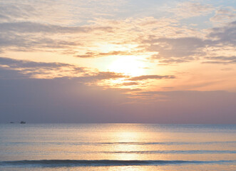 Naklejka na ściany i meble Beautiful sunset sky on the sand beach