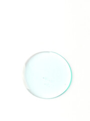 Blue liquid round trasparent swear on white isolated background. Bath gel or shampoo texture. Cosmetic swatch