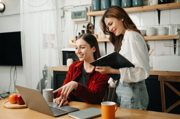 Two business workers talking on the smartphone and using laptop at the office.