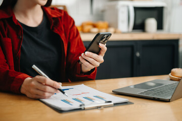 Businesswoman using mobile phone, tablet.Closeup on blurred background office.
