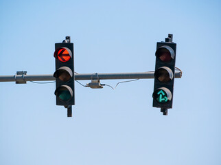 Traffic light against blue sky showing the color red.