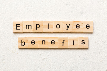 employee benefits word written on wood block. employee benefits text on table, concept