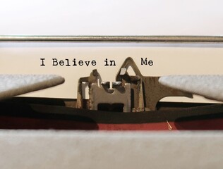 Old vintage typewriter with text typed I BELIEVE IN ME, concept of positive self talk or...